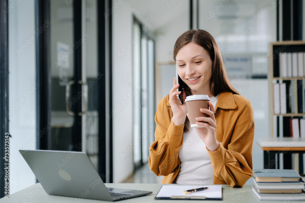 Confident woman with a smile standing holding notepad and tablet at the office. Confident woman with a smile standing holding notepad and tablet at the office.