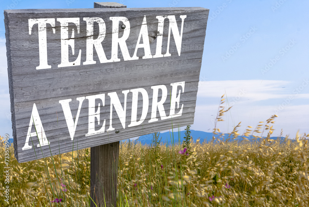 Terrain à vendre, marquage sur pancarte bois