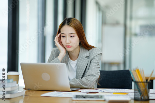 Female employees are stressed and tired. Headache from thinking and pressure from work.