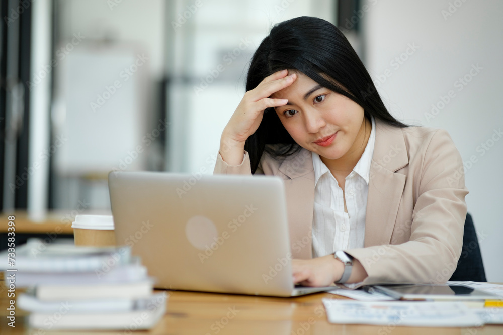 Female employees are stressed and tired. Headache from thinking and pressure from work. Female employees are stressed and tired. Headache from thinking and pressure from work.