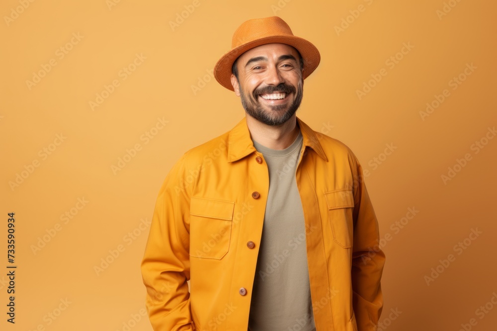 happy man in hat and raincoat smiling at camera isolated on orange happy man in hat and raincoat smiling at camera isolated on orange