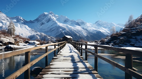 A frozen lake with a wooden pier stretching out into the icy water, surrounded by snow-covered mountains and a clear blue sky above