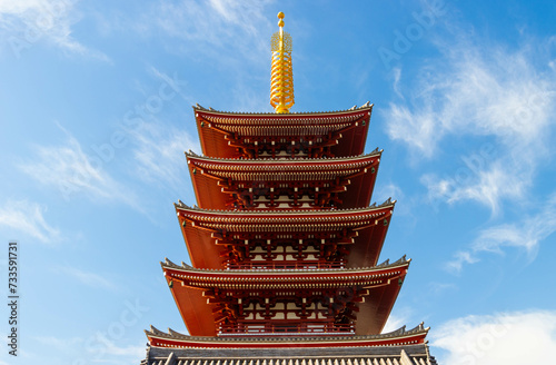 Red Japanese traditional five-storey pagoda against blue sky photo