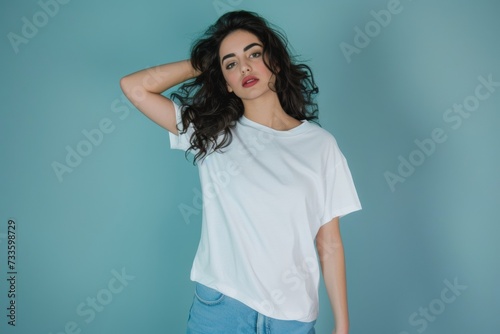 Studio shot of a young Middle Eastern woman with blank white t-shirt. T-shirt mockup design © Thuy Nguyen