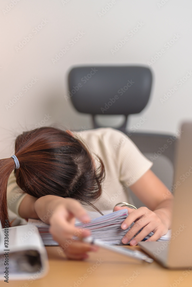 Stressed Asian woman having Tired and Sleepy while working, female businesswoman using laptop with headache at office, Exhausted woman with computer at home late night. Overload and Overworked