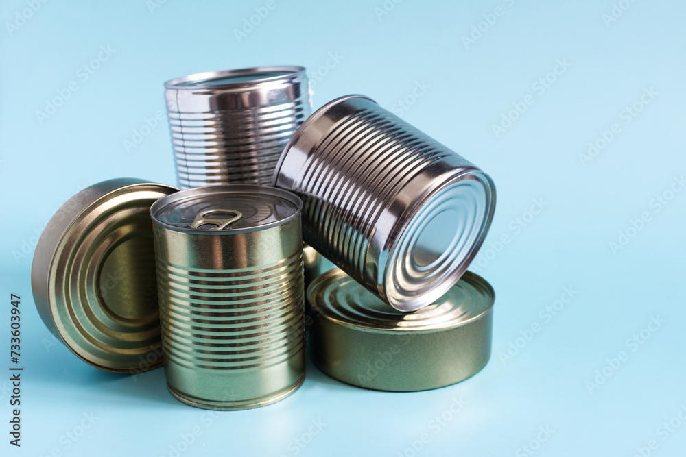 Tin cans with various products in close-up on a colored background. Long-term storage products. Tin cans with various products in close-up on a colored background. Long-term storage products.