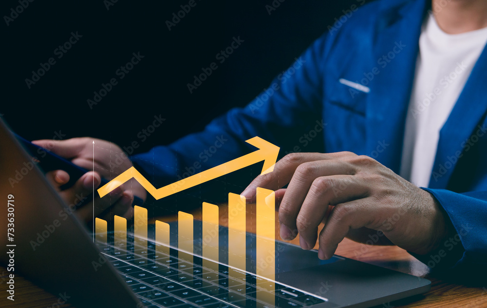 Businessman analyzes company growth using laptop, studying future business growth through arrow graphs. Developing strategies to achieve long-term goals, business outlook, financial data investments.