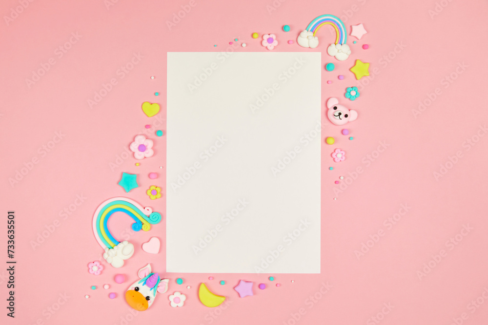 Blank white card on pastel pink background with frame of cute kawaii air plasticine handmade cartoon animals, stars, rainbows. Empty photo frames, baby's photo book, scrapbooking design template