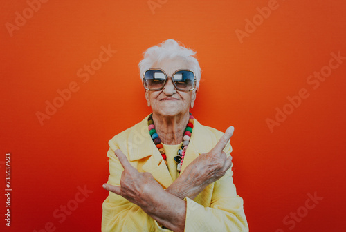 Funny grandmother portraits. Senior old woman dressing elegant for a special event. Rockstar granny on colored backgrounds