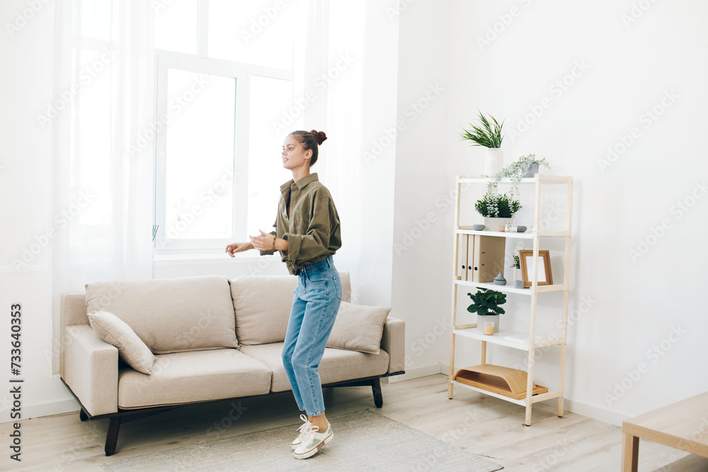 Joyful Woman Jumping with Music in a Relaxing Home Environment