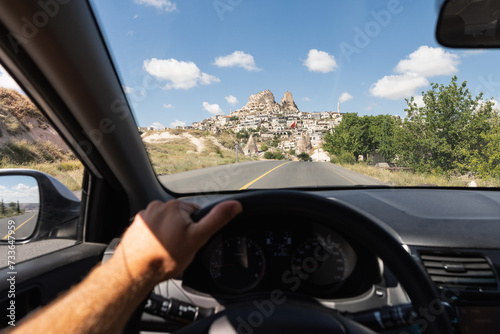 Driver seat view over the Cappadocian town Uchisar, Turkey.
