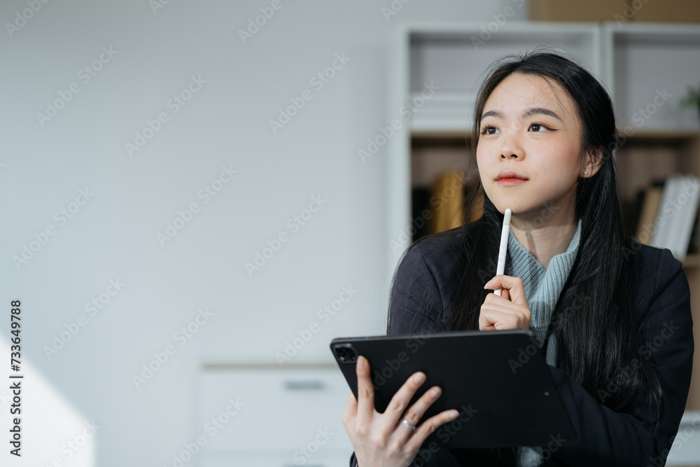 Businesswomen working with smart phone and laptop and digital tablet computer in office with digital marketing media. Businesswomen working with smart phone and laptop and digital tablet computer in office with digital marketing media.