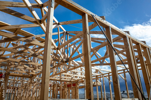 Wooden structure or timber frame of a residential suburban home at a construction site. Concept of self build home, housing market in Australia, house and land package and unfinished carpentry work.