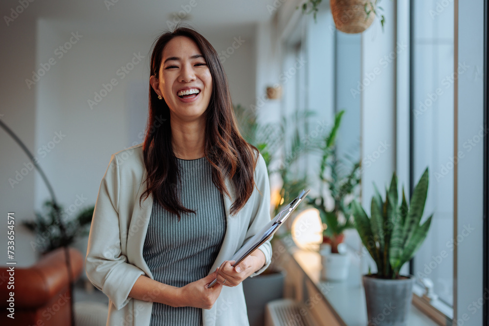Asian woman posing and smiling at work Asian woman posing and smiling at work