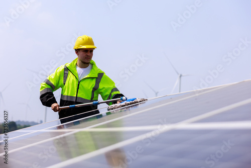Man is working on cleaning solar panels.