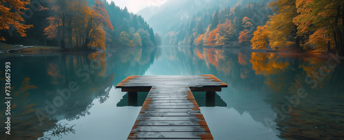 Pier on a lake in the mountains in the morning mist.