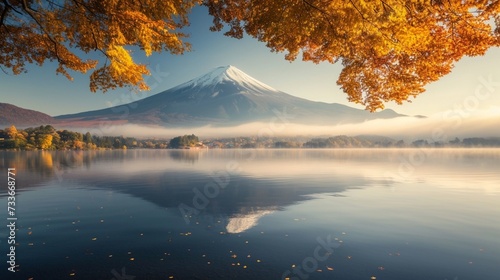 Discover the enchanting blend of autumnal colors at Lake Kawaguchiko, with the majestic Mount Fuji standing tall amidst morning fog