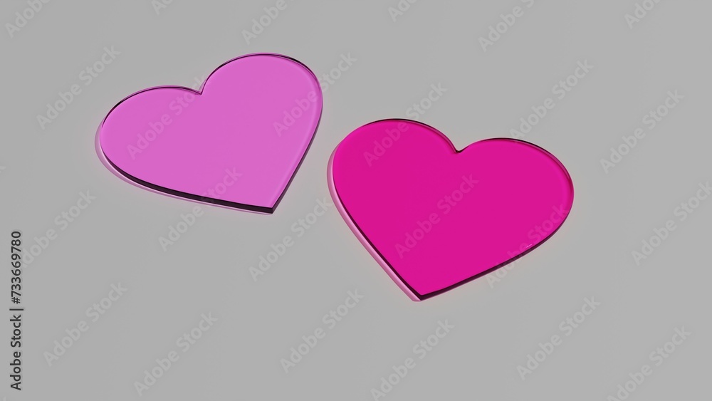 Dwa szklane różowe serca na szarym tle