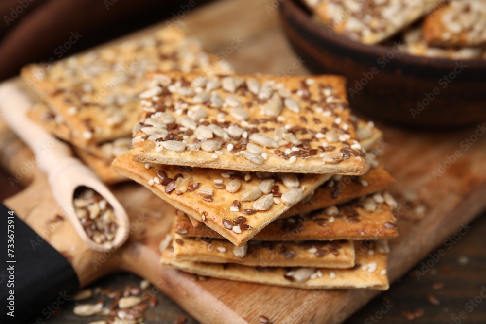Cereal crackers with flax, sunflower and sesame seeds on table, closeup