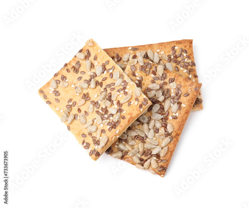 Cereal crackers with flax, sunflower and sesame seeds isolated on white, above view