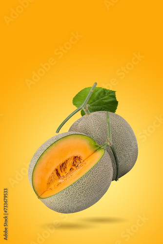 Fresh Melon and Melon slices on a pastel yellow background. Fruit minimal concept and copy space.