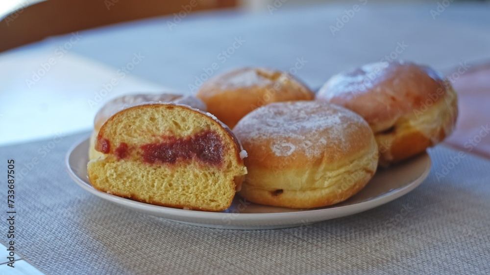 Sweet Delicious Traditional Polish Glazed Doughnut Paczek Filled with Sweet Jam Marmalade Prepared for Dessert on Fat Thursday Celebration before Ash Wednesday and Lent