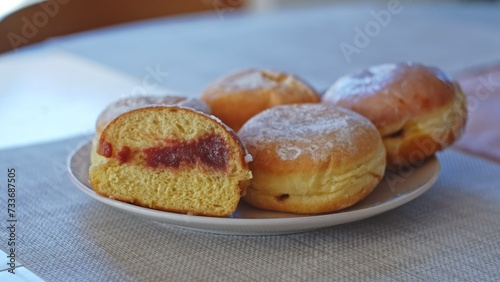 Sweet Delicious Traditional Polish Glazed Doughnut Paczek Filled with Sweet Jam Marmalade Prepared for Dessert on Fat Thursday Celebration before Ash Wednesday and Lent