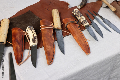  Handmade imitations of medieval knives in knight camp at the festival of historical reconstruction photo