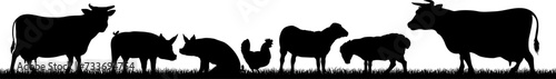 A farm animals scene with silhouettes of cows, chicken, sheep and pigs in a grass field scene landscape photo