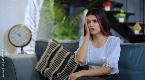 Photos Indian tired tense abuse afraid young female girl sitting sofa couch watch bad T