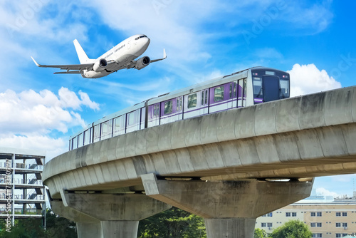 View railway track suburban subway electric train rushing to . Passenger plane flying in sky, take off landing at airport. Concept of modern infrastructure transport travel.
