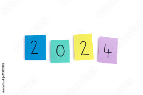 2024 written on four seperate colorful sticky notes - isolated on white background, image for the new year 2024