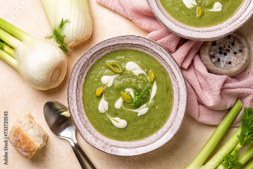 Creamy vegetable fennel, leek and spinach soup with vegan cream. Top view. Fresh bread. photo