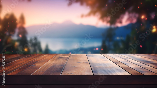 Wooden table fronting a serene lake and mountain view at sunset, pink and purple hues, table mockup photo