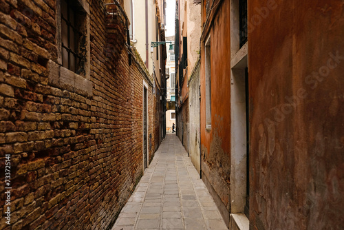 Typical narrow street with historical houses in Venice. Narrow pedestrian streets of Venice between the channels. 