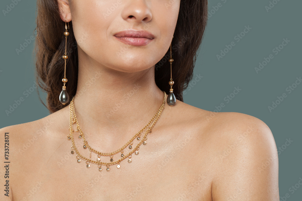 Gold jewelry model. Woman with bijou close up
