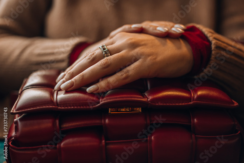  Woman wears leather red mini Bottega Veneta Cassette bag, street style details. photo