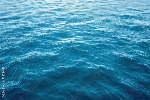 Turquoise blue colored calm sea surface texture.