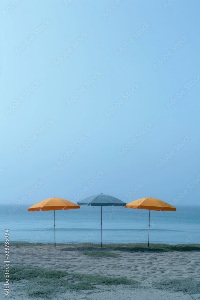 three beach umbrellas in the distance