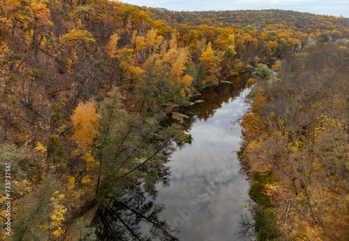 Autumn aerial view on river with colorful trees on riverbanks. Autumnal Siverskyi Donets River in Ukraine