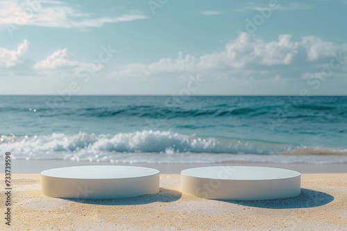 Two empty round platform podiums on the beach sand
