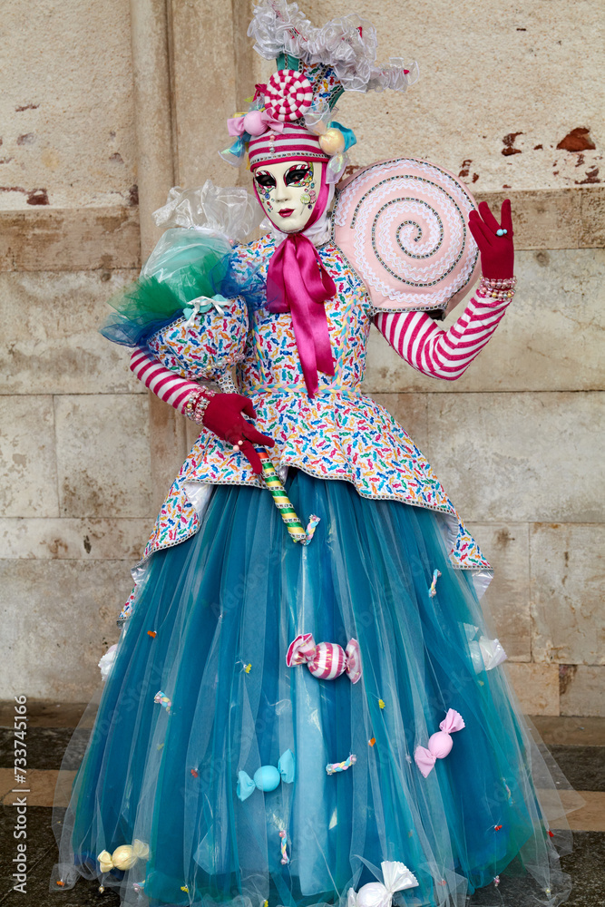 Venice, Italy - February 2024 - carnival masks are photographed with tourists in San Marco square Venice, Italy - February 2024 - carnival masks are photographed with tourists in San Marco square