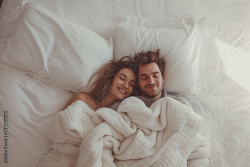 A married couple is basking in bed