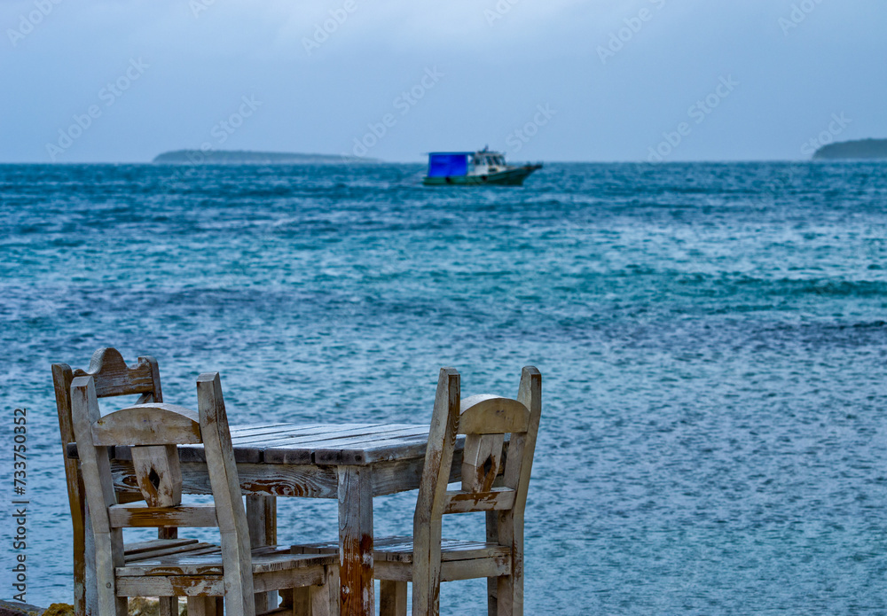 wooden chair on the beach and boat 