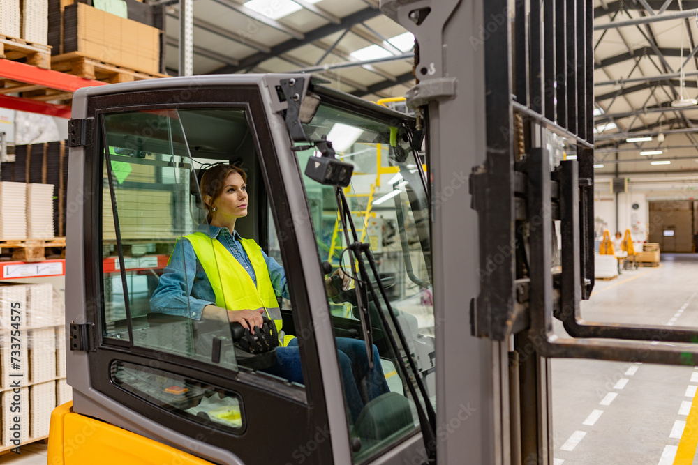 Female warehouse worker driving forklift. Warehouse worker preparing products for shipmennt, delivery, checking stock in warehouse. Female warehouse worker driving forklift. Warehouse worker preparing products for shipmennt, delivery, checking stock in warehouse.