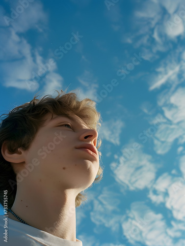 Dreamy shot of a young male in the blue sky, Generative AI