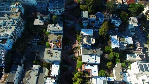 Aerial Panning Shot Of Famous Winding Road Amidst Residential Buildings, Drone Flying During Sunny Day - San Francisco, California