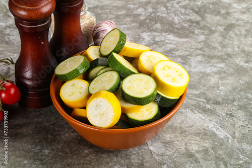 Sliced raw young green and yellow zucchini