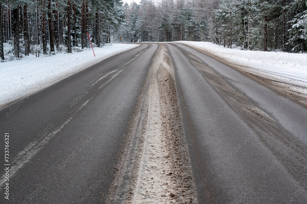 Winter road through forest in Hallsberg Sweden Winter road through forest in Hallsberg Sweden
