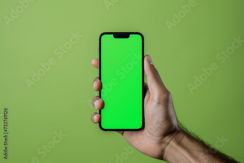 phone in hand, green background